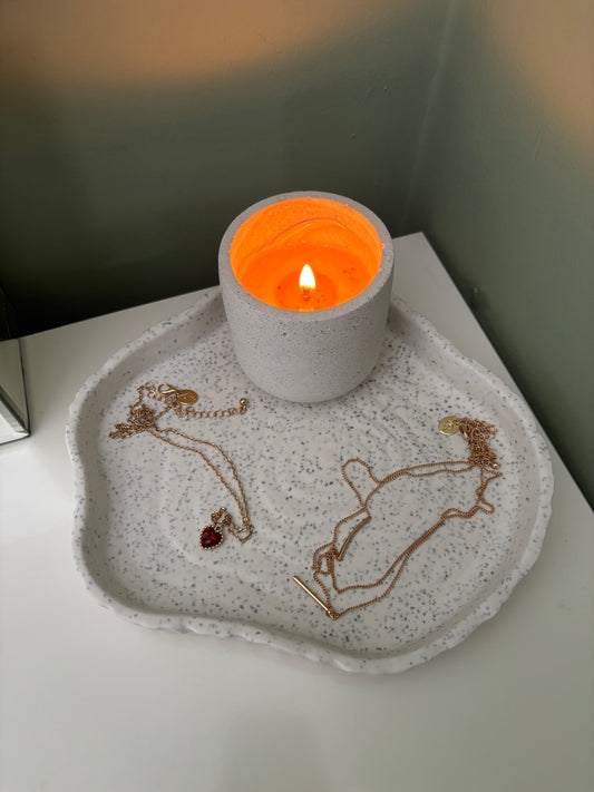 granite curved tray displaying candle and necklace