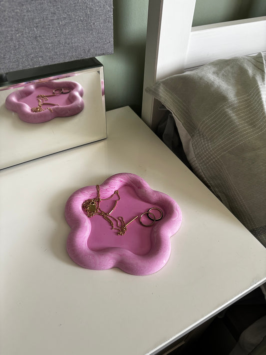 pink tray with jewellery on