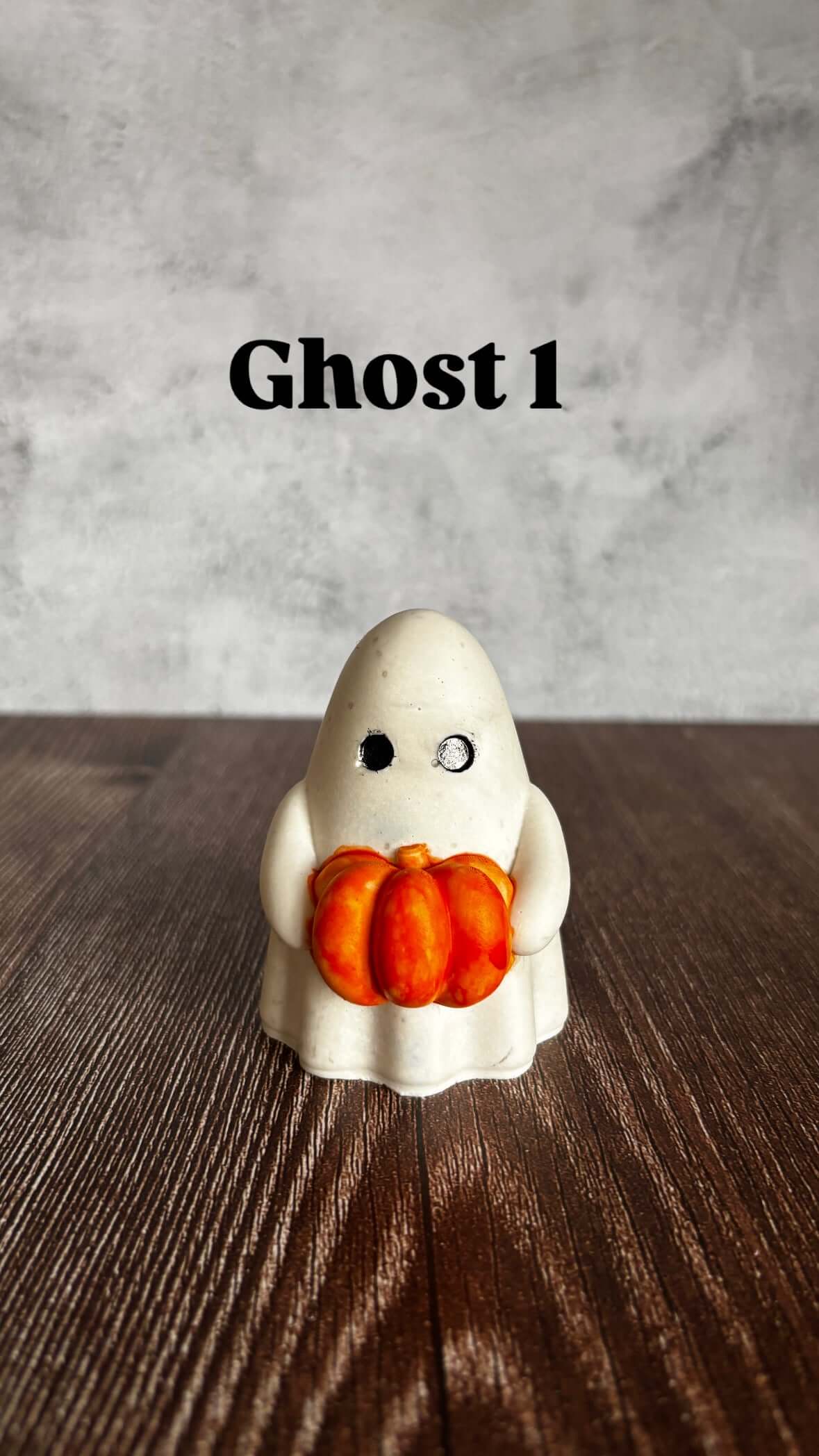 ghost holding orange pumpkin