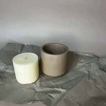 Soy wax candle refill and vessel on textured surface, showcasing sustainable home fragrance options.