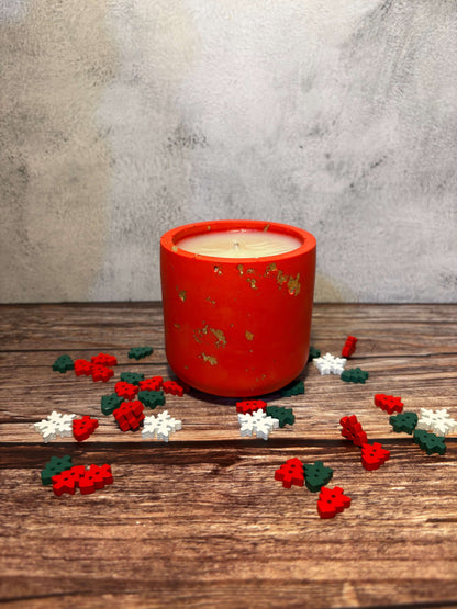Christmas Marketsd in Munich Red candle with decorative flowers on a wooden surface