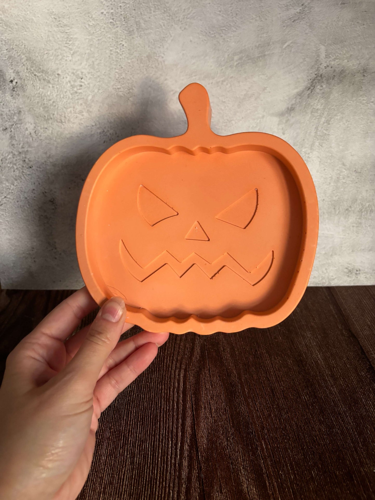 holding orange pumpkin tray 