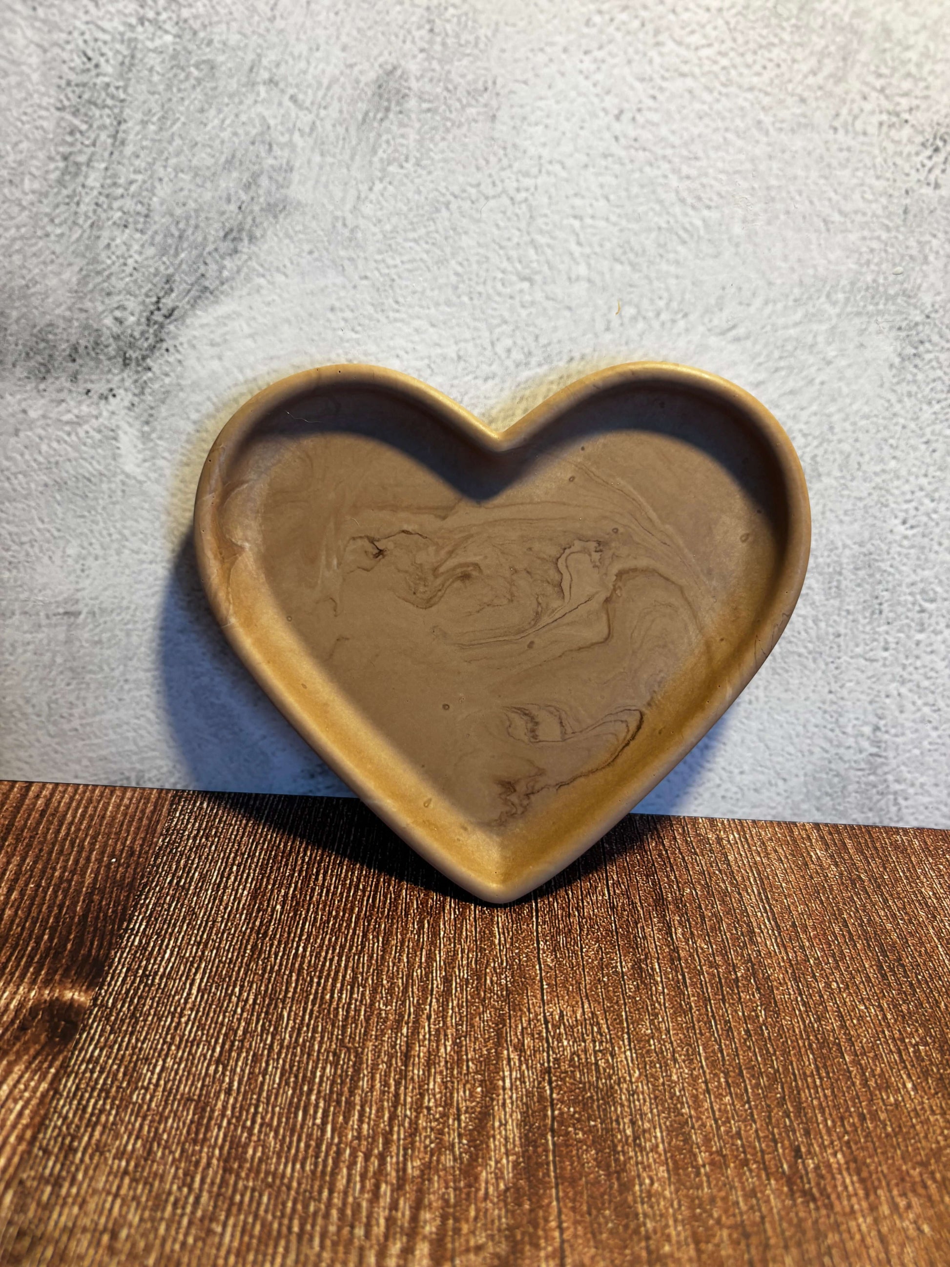 Heart-shaped ceramic dish on a wooden surface